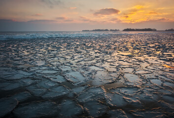 Wall Mural - Sunrise and frozen sea. Beautiful winter landscape with lake in morning time.