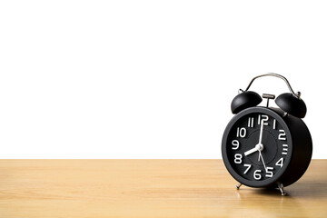 Black alarm clock retro style on wooden floor table. concept watch for add text message or art work design. pointer in 8 o'clock.