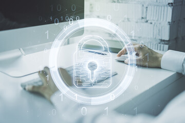 Aufkleber - Double exposure of creative lock hologram with chip and hands typing on laptop on background. Information security concept