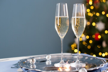 Wall Mural - Glasses with champagne near Christmas tree