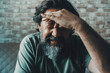 © simona - Headache and migraine unhealthy concept. Man touching his front and do painful expression for problems and ache. Stressed and worried people at home indoor. Portrait of male with flu symptom influenza