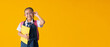 © kromkrathog - Back to school banner idea concept, Funny smiling child school girl with hold books, isolated on yellow background with Clipping paths for design work empty