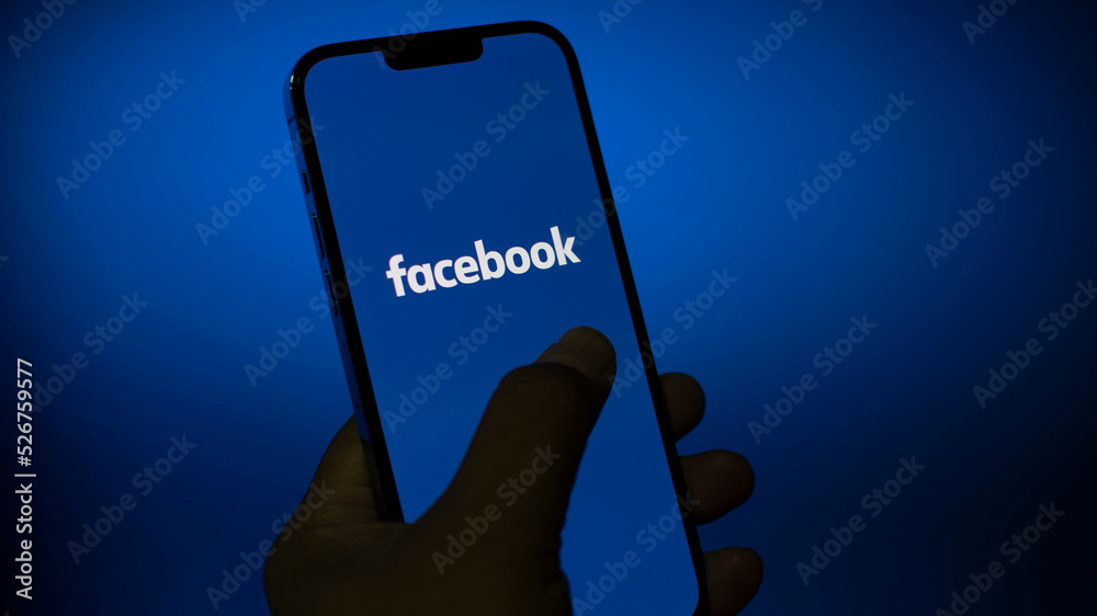 facebook application on mobile phone screen in hand, Social media ...