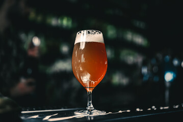 Wall Mural - glass of beer stands on bar counter in a bar or pub