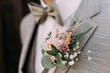 Groom in light grey with flowers at Wedding Day