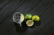 gin and tonic with citrus fruit and thyme on a black background