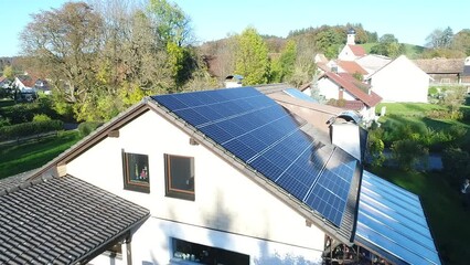 Wall Mural - Solar panels and sunlight reflextions on the roof against blue sky background. Concept clean power energy.
