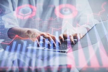 Double exposure of woman hands typing on computer and forex chart hologram drawing. Stock market invest concept.