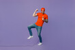 © ViDi Studio - Full body young excited happy singer fun man 20s he wear red hat t-shirt isolated on plain pastel light purple sing song in microphone at karaoke club perfomance do winner gesture background studio.