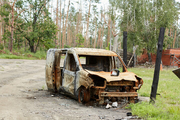 Wall Mural - Car riddled with bullets. War of Russia against Ukraine. A car of civilians shot by the Russian military during the evacuation of women and children. Traces of bullets and fragments of shells