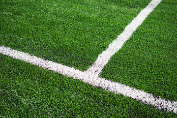 Wall Mural - Green synthetic grass sports field with white line.