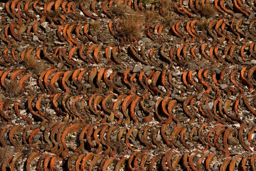 Orange roof tiles on the slope of a Dutch seawall