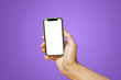 © Benoît - Mobile phone with empty white screen in hand on bright purple background