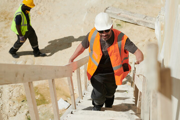 Aufkleber - Middle aged male foreman or worker of industrial factory moving upstairs along staircase while working on territory of marble quarry