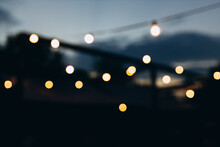 Decorative Outdoor String Lights At Night Time, Defocused Background, Night City Life Backdrop, Party Time With Yellow Bokeh Balls