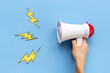 Attention and hot news concept. Megaphone with flying lightning