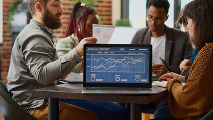 Diverse team of people working with research analysis and online statistics on laptop, analyzing rate charts and data graphs, Planning teamwork presentation with computer software. Close up.