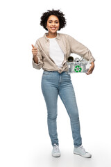 Wall Mural - metal recycling, waste sorting and sustainability concept - happy woman holding plastic box with tin cans showing thumbs up over white background