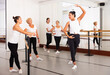 © JackF - Choreographer conducting classes in a ballet studio shows a female group the correct performance of a choreographic exercise