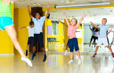 Wall Mural - Emotional children performing modern dance in fitness studio. High quality photo