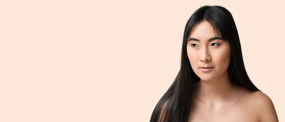 Poster - Young Asian woman with beautiful long hair on light beige background with space for text