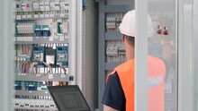 Electrical Engineer Working Check The Electric Current Voltage And Overload At Front Of Load Center Cabinet Or Consumer Unit For Maintenance In Main Power Distribution System Room.