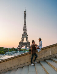 Sticker - Eiffel tower at Sunrise in Paris France, a Young couple in a city trip by Eiffel tower at Sunrise, man woman in love, valentine concept in Paris the city of love