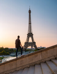 Sticker - Young men watching sunrise by the Eiffel tower, Eiffel tower at Sunrise in Paris France, Paris Eifel tower on a summer day in the city of Paris France