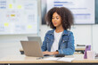 © David - Excited happy Asian woman african american sitting on desk in workplace, doing planning analyzing the financial report, business plan investment, finance analysis concept.