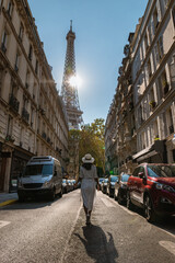 Sticker - Young women with a hat visiting Eiffel tower at Sunrise in Paris France, Paris Eifel tower on a summer day in the city of Paris France