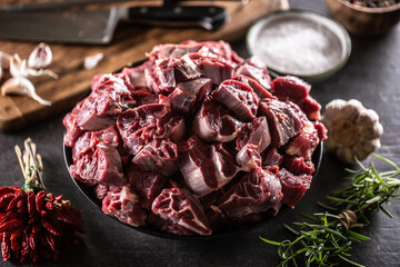 Wall Mural - Bowl of raw cuts of beef with herbs and garlic ready for making a hearty soup or stew