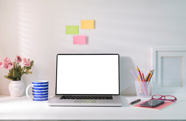 Aufkleber - Laptop with blank screen, picture frame, flower pot and notebook on white table. Feminine workplace.