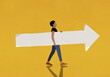 © fStop - Man carrying paper arrow on yellow background