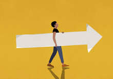 Man Carrying Paper Arrow On Yellow Background
