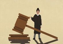 Female Judge Standing At Large Gavel
