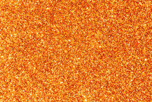 Surface Background Covered With Orange Shiny Sequins. Orange Grainy Ground Background.