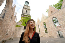Young Woman Visiting The Ruins Of The Church Of Aegidienkirche In Hanover, Germany