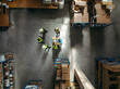 © Jacob Lund - Aerial view of warehouse workers having a meeting