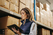 © Jacob Lund - Female logistics worker doing stock control using a digital tablet