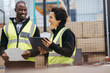 © Jacob Lund - Happy warehouse workers smiling cheerfully during a meeting
