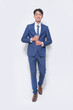 © William WANG - Full body young businessman wearing suit, blue shirt with tie standing in studio