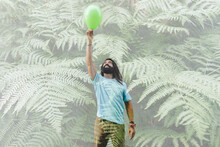 Multiple Exposure Of Plants With Man Holding Balloon