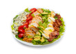 Cobb salad of romain lettuce, slices bacon, avocado, chicken, tomato, eggs, blue cheese, in a white salad bowl isolated on white background.