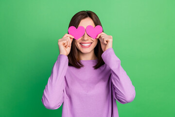 Wall Mural - Photo of romantic lovely girl hide her face with small oink hearts isolated on green color background