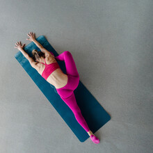 Young Sporty Woman On Yoga Mat Straightening All Body For Improving Flexibility