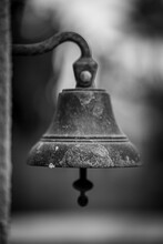 Vertical Greyscale Shot Of A Rusty Bell