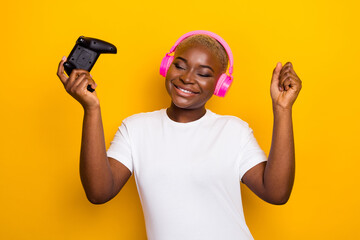 Wall Mural - Photo of funny funky girl user modern technology device raise hands enjoy celebrate success achieve isolated on yellow color background