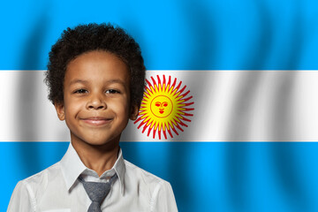 Wall Mural - Argentine kid boy on flag of Argentina background. Education and childhood concept