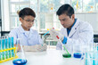 © pixs4u - Young teacher and student boy in science class at laboratory