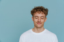 Portrait Of Young Handsome Curly Man With Closed Eyes